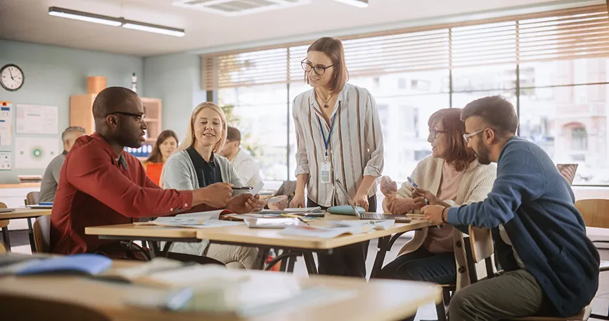 Teachers working together around a table in a classroom